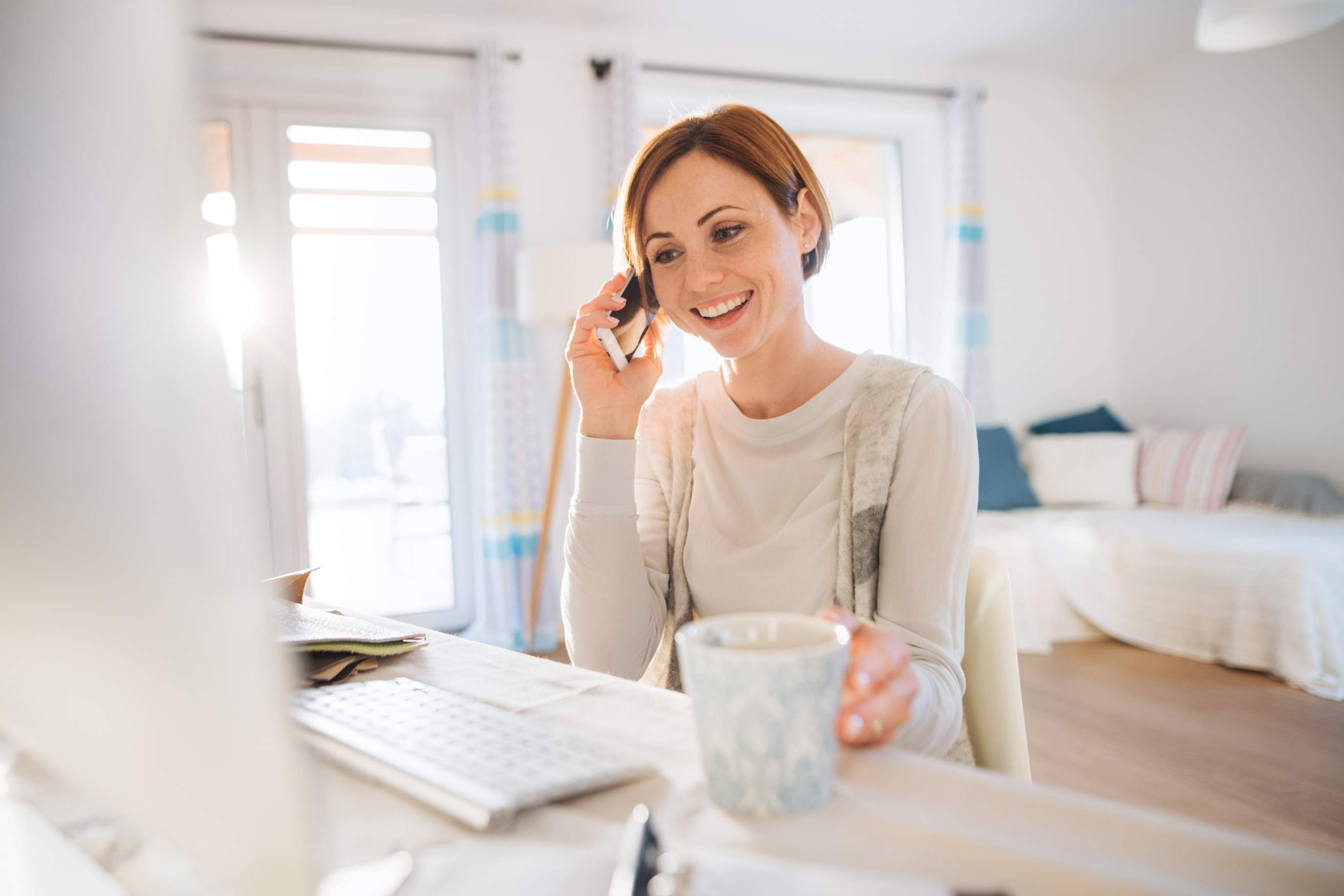 Host using a phone in a beautiful rental space